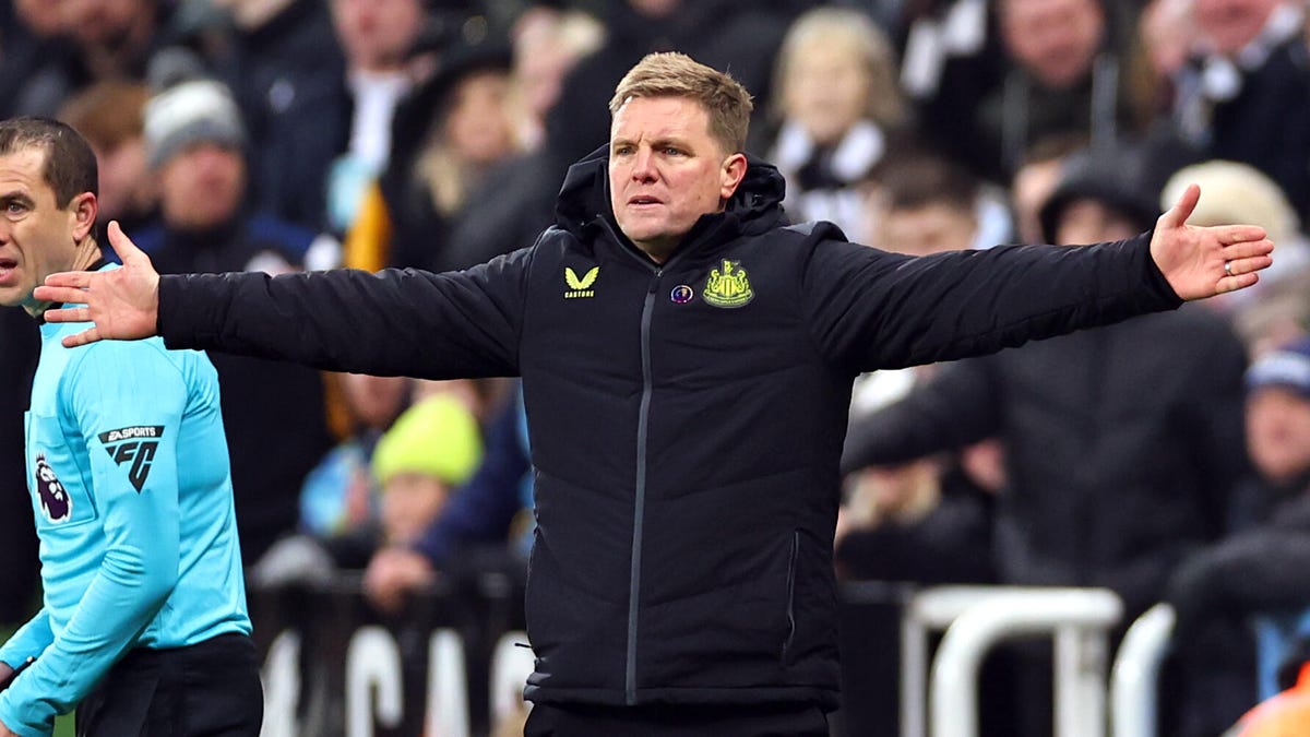 Newcastle United manager Eddie Howe standing with both arms outstretched.