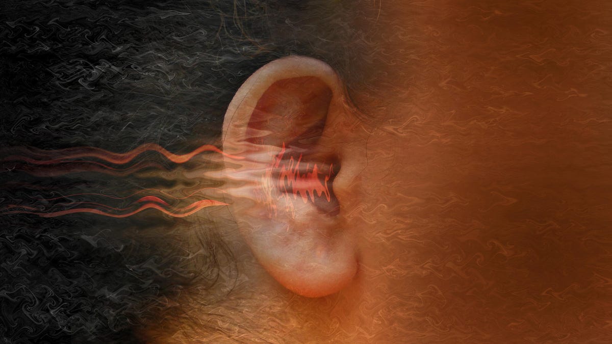 Close-up of a person&apos;s ear with red lines flowing into it