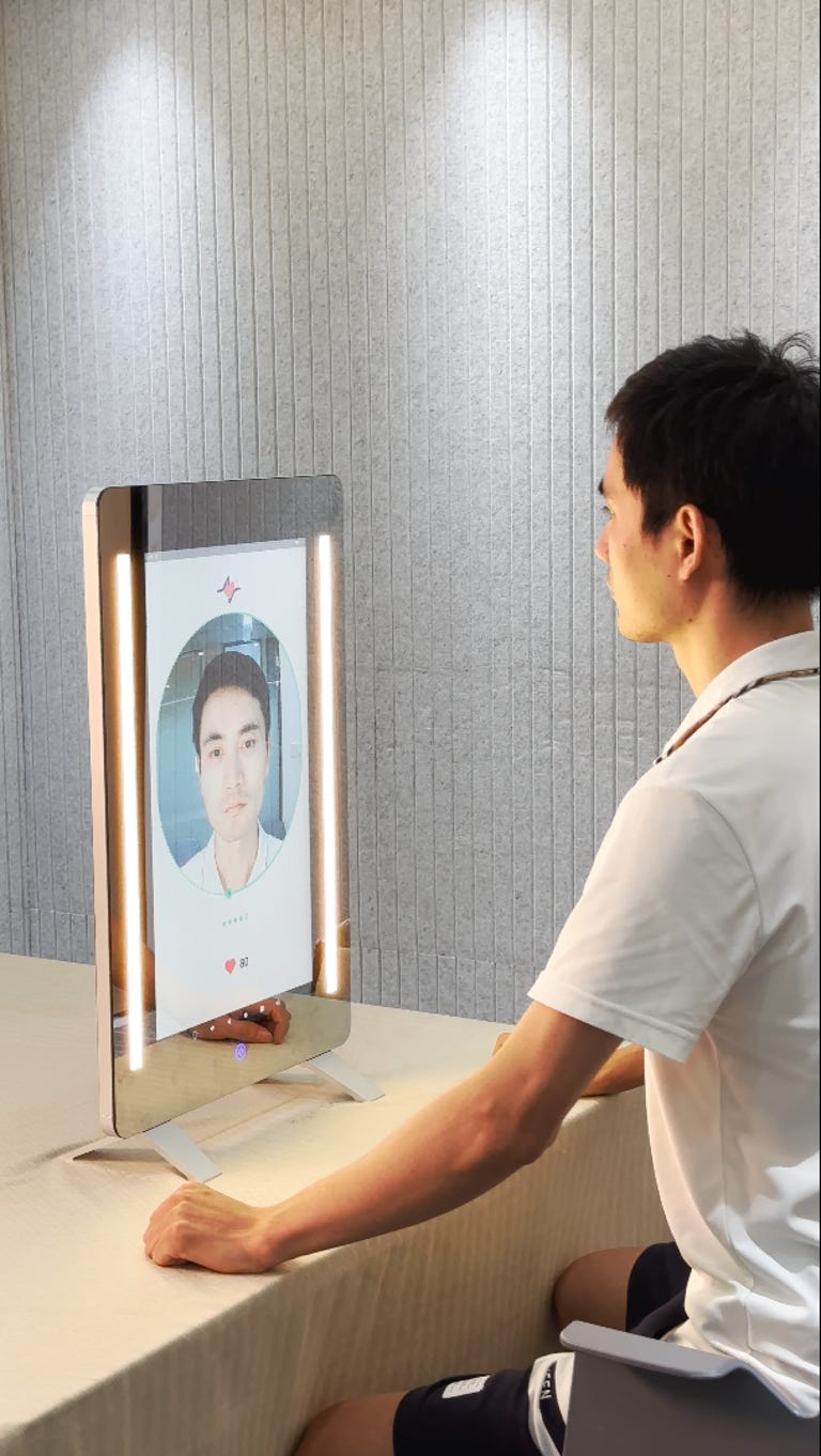 A person sitting in front of the MagicMirror
