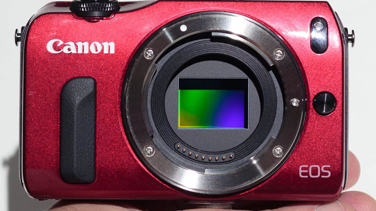 Canon's EOS M uses a relatively large APS-C sensor like its bigger SLR brethren, but ditching the SLR mirror means the camera body is smaller.