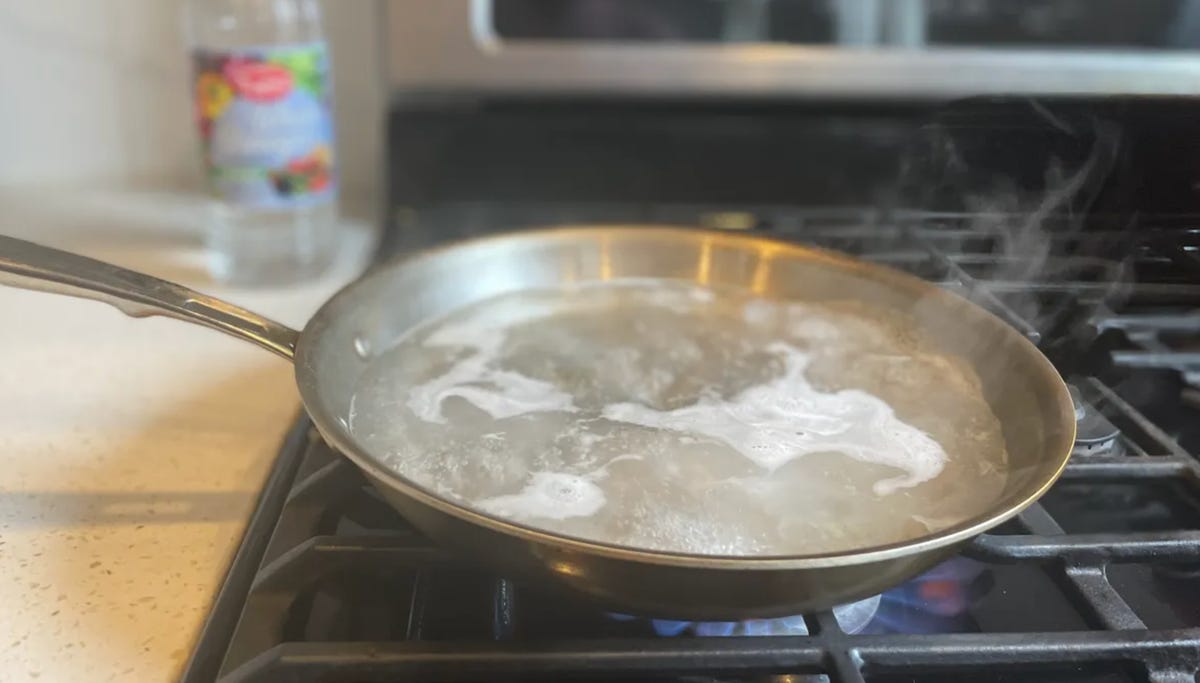 pan on stove with boiling cleaning solution