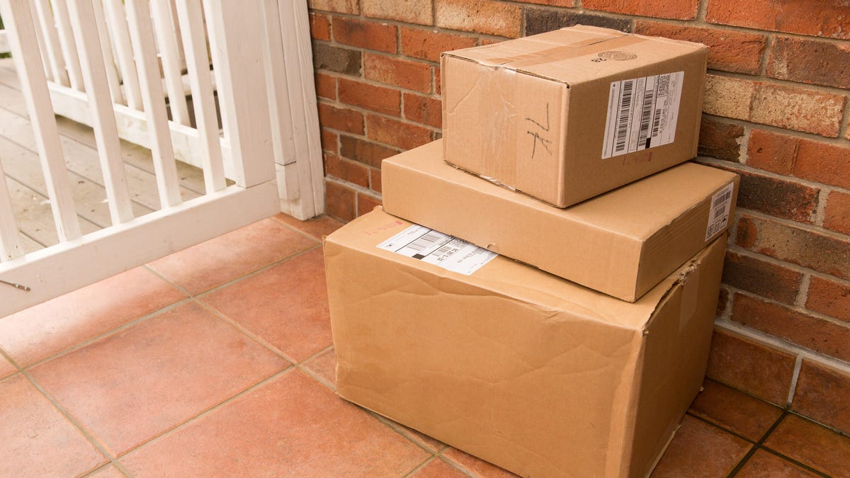 Three packages of different sizes sitting on a porch