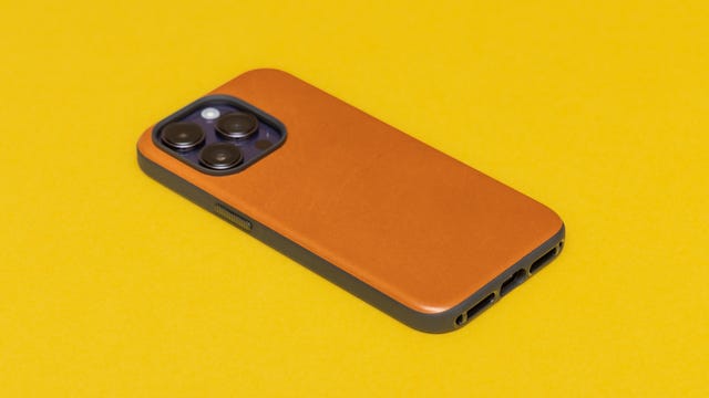 An iPhone 14 Pro in a leather case with three cameras pointing upward