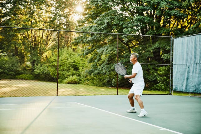 A middle-aged man playing tennis