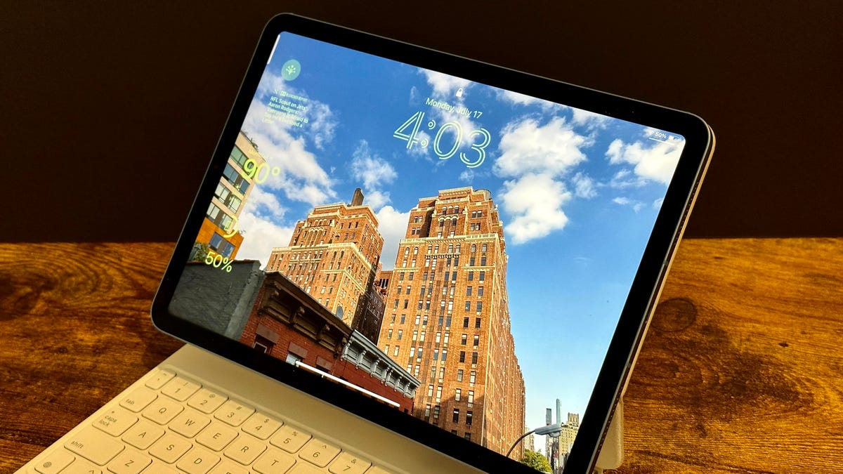 iPad lock screen with cityscape photo, iPad in keyboard case on table