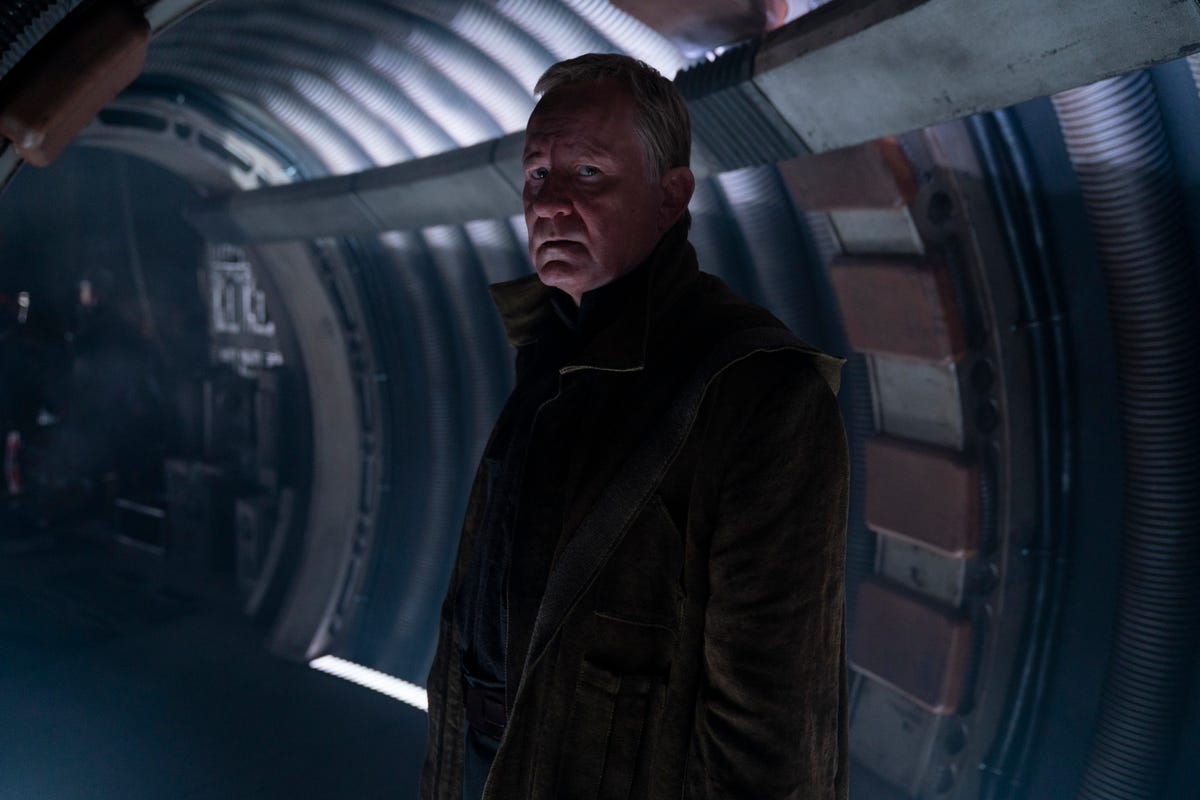 Luthen Rael looks intently at the camera he stands in the corridor of his ship in Andor