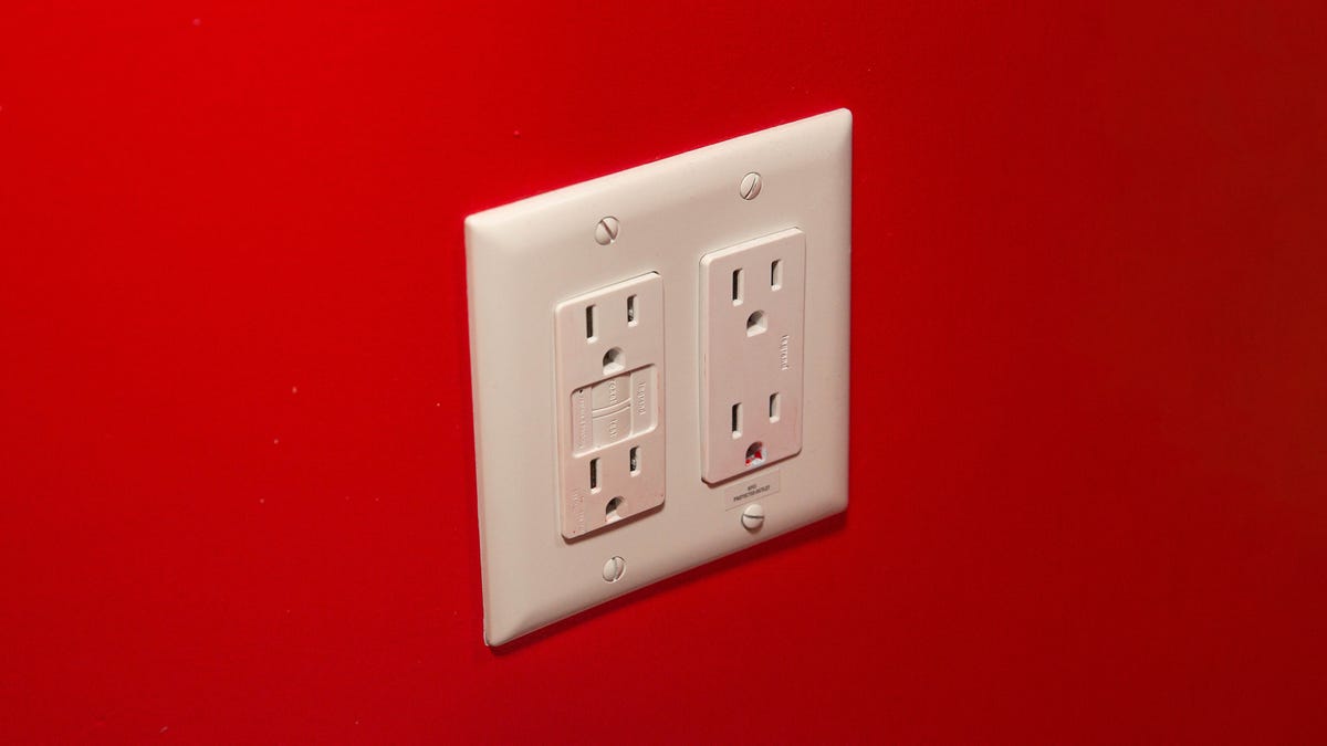 A red wall with four outlets