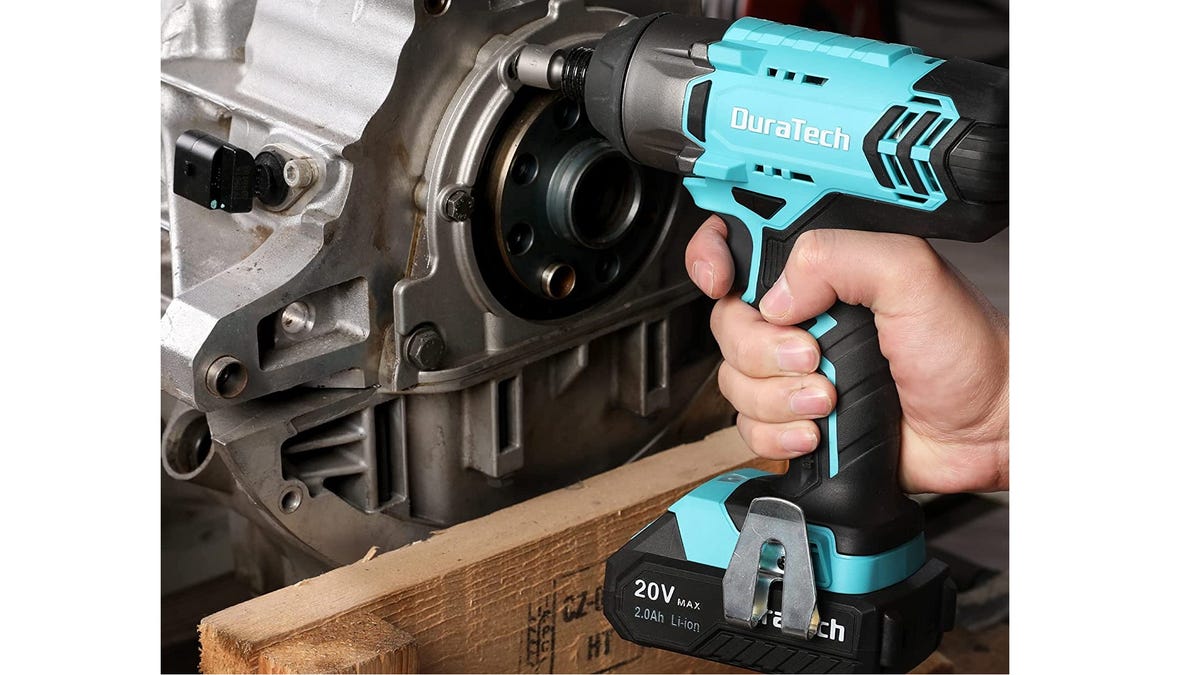 Someone using a blue Duratech cordless drill.