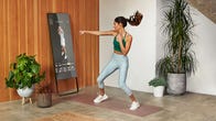woman working out in front of a mirror device