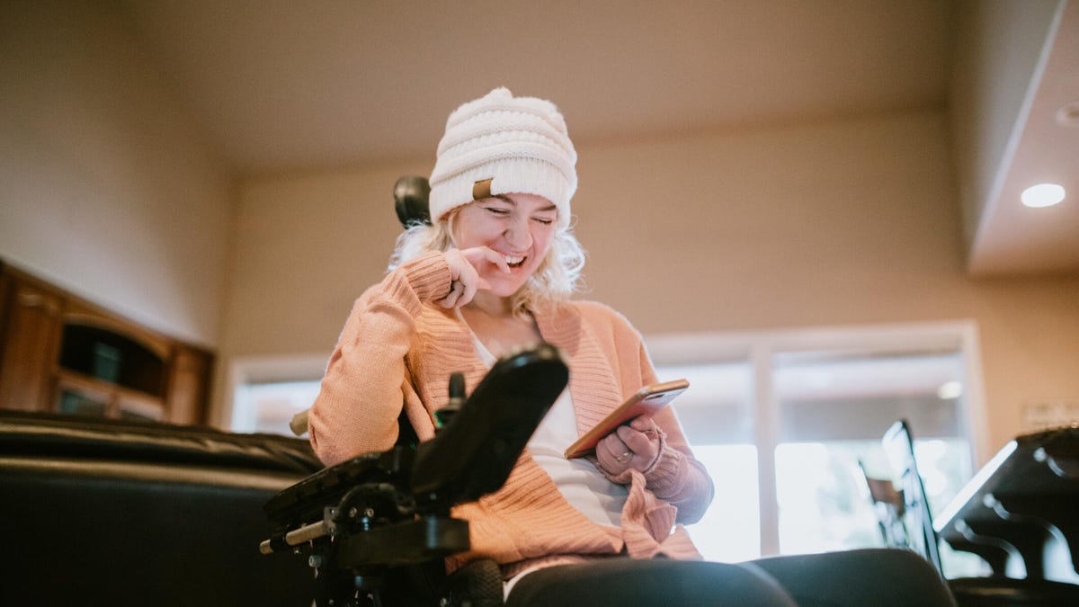 Woman in wheelchair looking at her smartphone