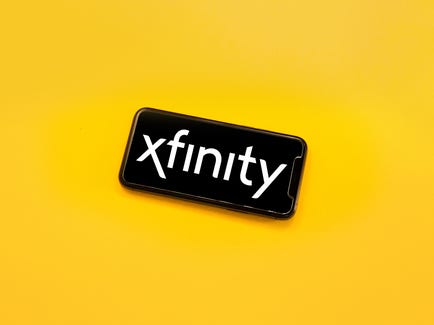 A phone displays the Xfinity Logo