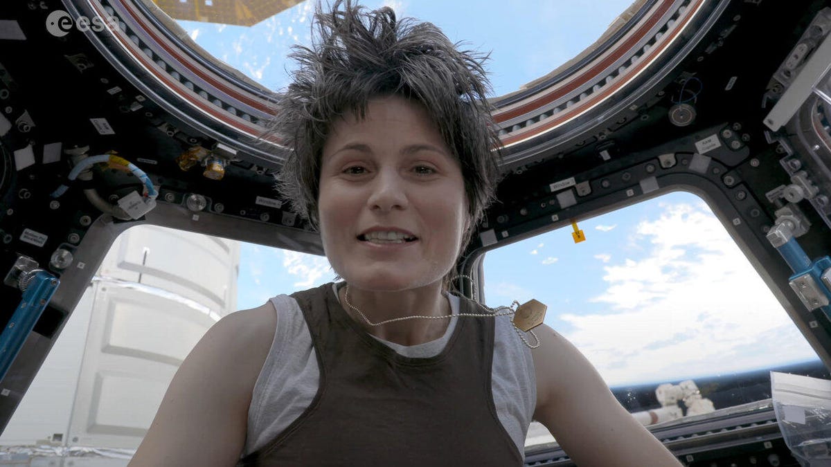 ESA astronaut Samantha Cristoforetti floats in front of ISS windows while dressed as Starbuck from Battlestar Galactica.