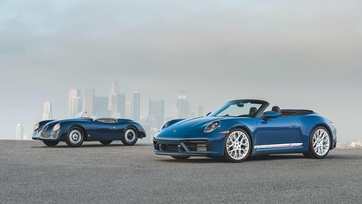 Two Porsche 911 Carrera GTS Cabriolet America Editions parked in front of a misty cityscape