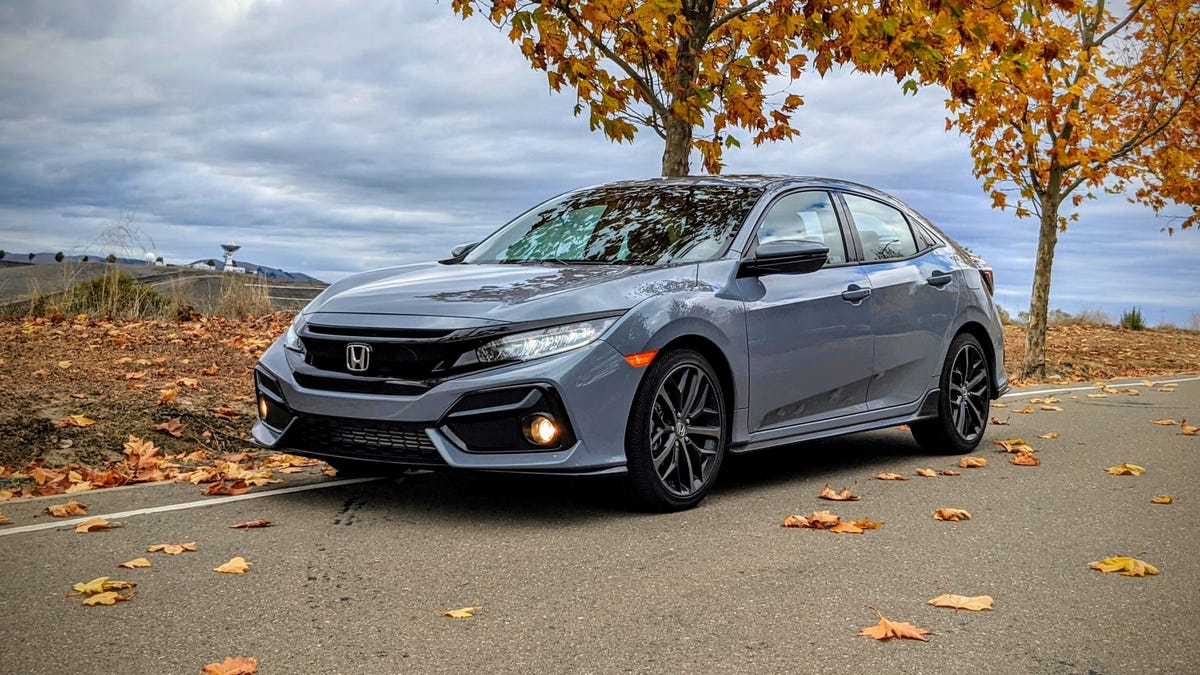 gray 2020 Honda Civic Hatchback parked next to trees with autumnal foliage