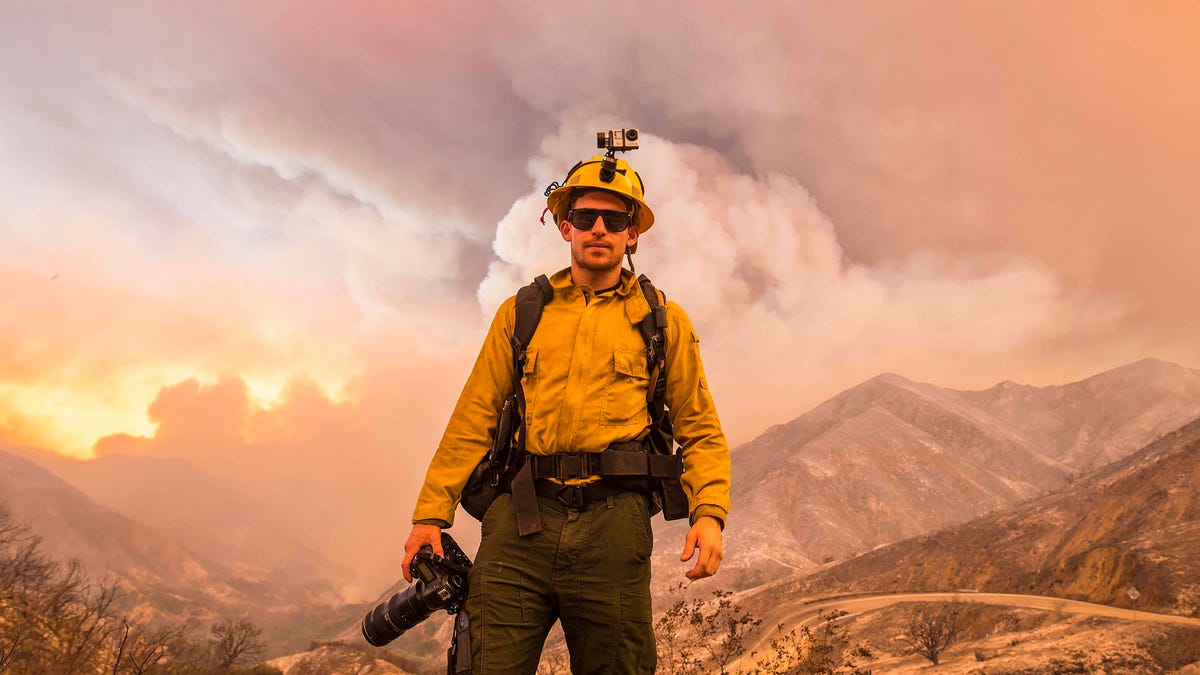 Stuart Palley, a professional wildfire photographer standing in the Angeles National Forest, believes mirrorless cameras will replace conventional SLRs.