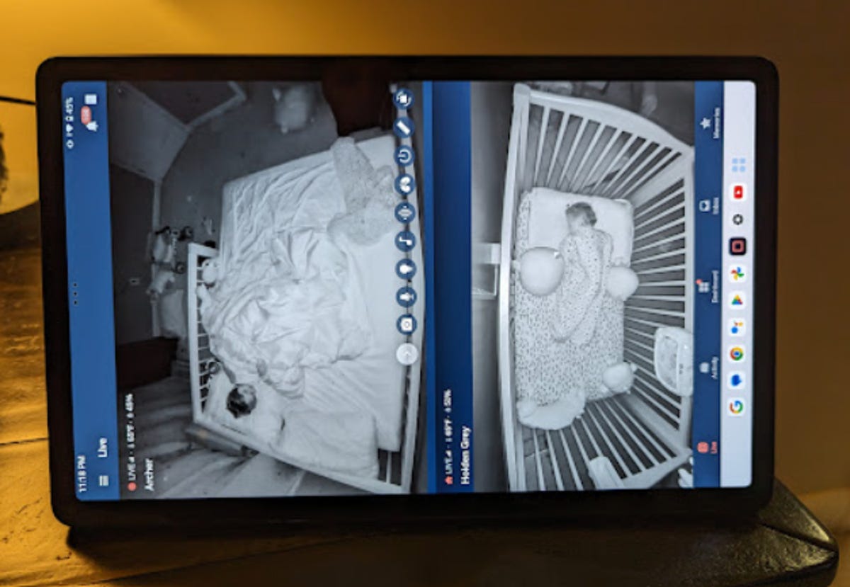Tablet with a split screen showing two young buys asleep on a baby monitor