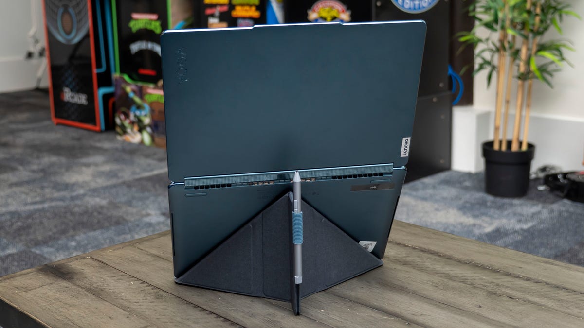 A look behind the Yoga Book 9i's folding stand with its active stylus in its holder.