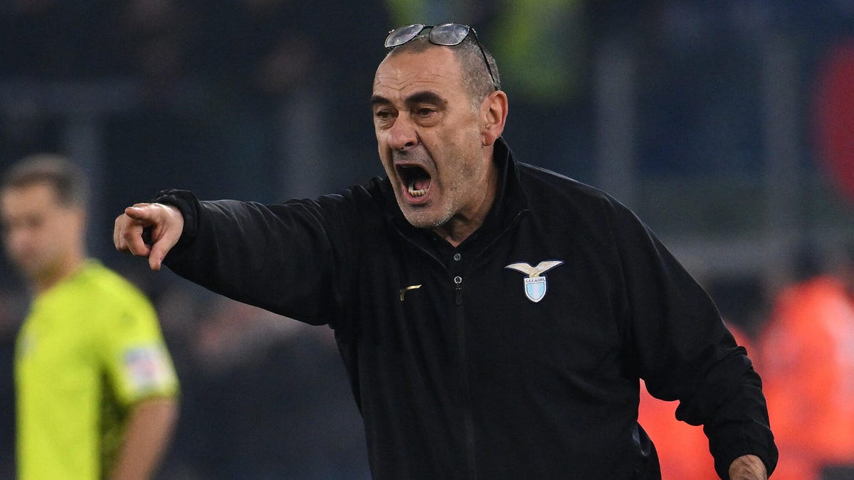Lazio coach Maurizio Sarri with glasses rested on top of his head, shouting, pointing with his right hand.