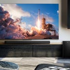 A TCL Alto 8 Plus soundbar and subwoofer in a living room with a TV