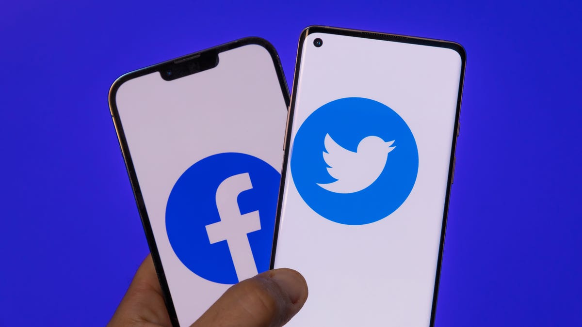 Facebook and Twitter social media logos on mobile phones