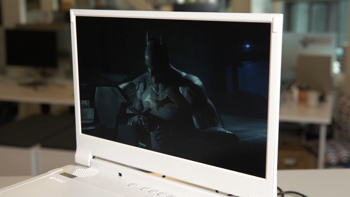 The Depgi screen with an office in the background and Batman on the display