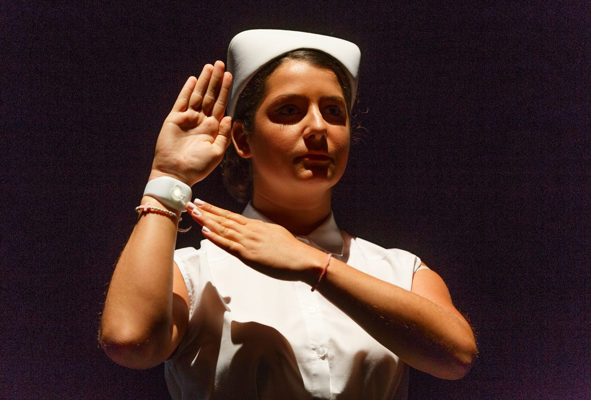 ​A nurse-attired actor shows off the emotion sensor.