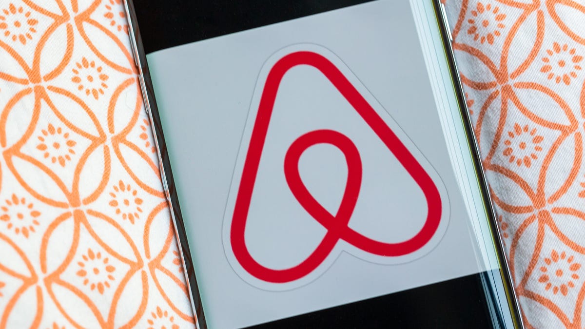 Airbnb logo on a phone screen