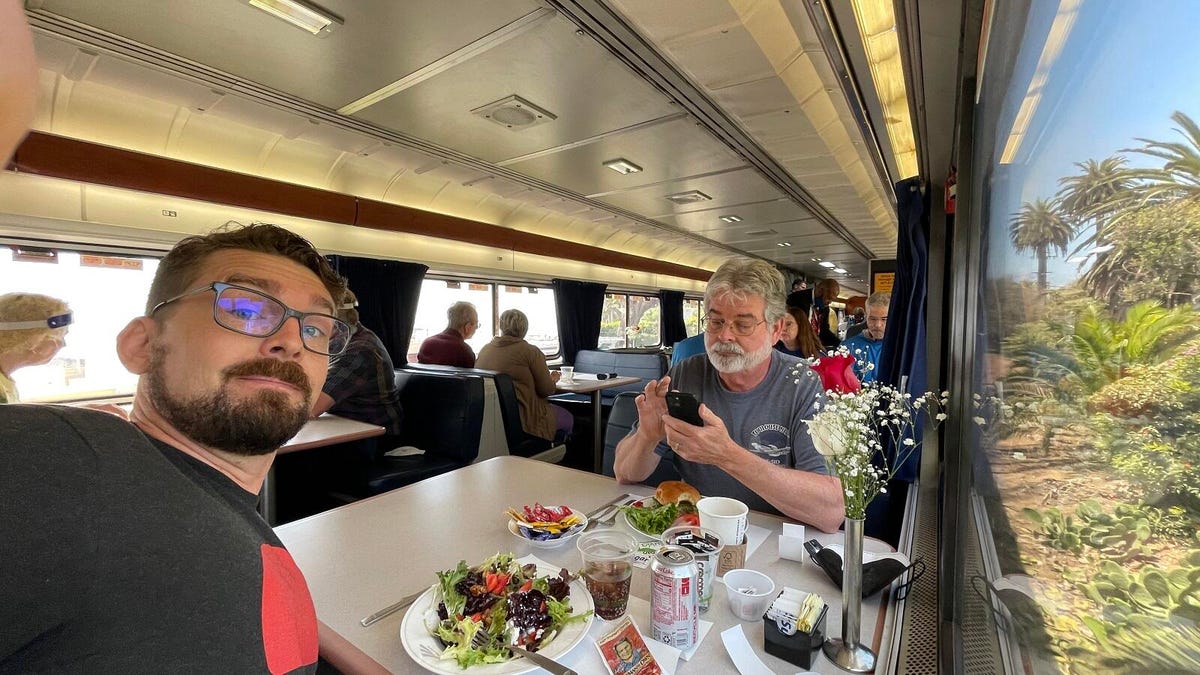 The reporter taking a selfie with his dad during a lunch of goat cheese and strawberry salad and hamburger while California speeds by the window.