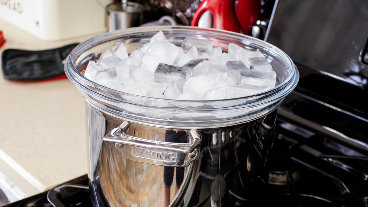 ice in an upside down lid placed on top of a pot
