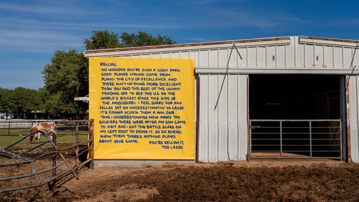 A yellow billboard with an encouraging message written for Kellyn Acosta by Ted Lasso
