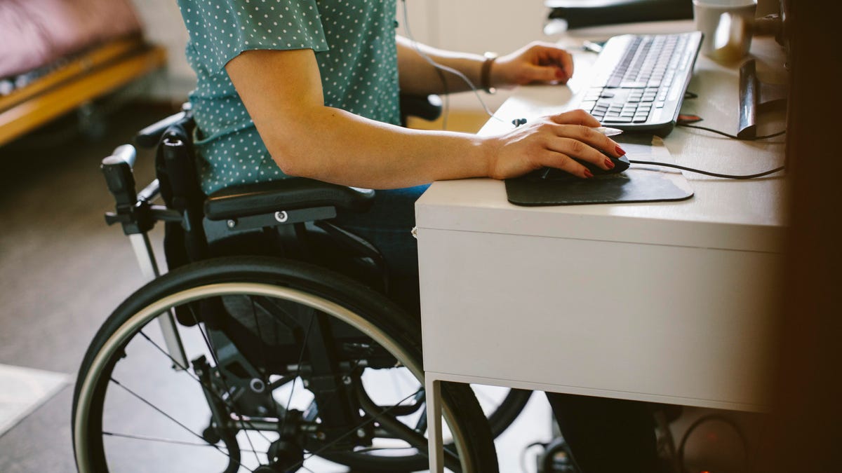 Wheelchair user at a computer