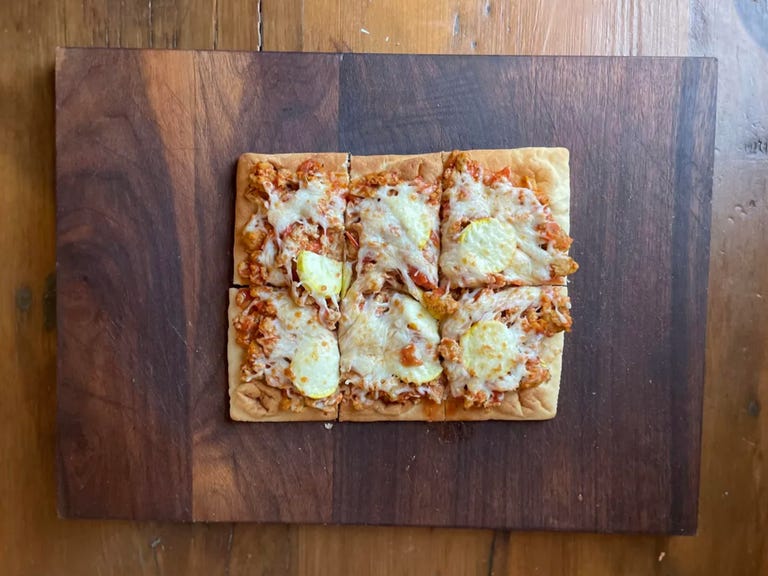 flatbread pizza on cutting board
