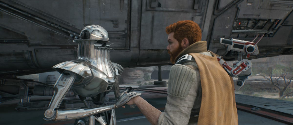 A droid holds Cal's hand