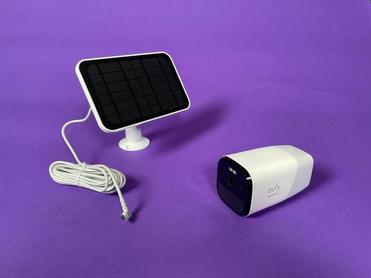 The Eufy 4G Starlight Cam and its solar panel charger accessory against a purple background.