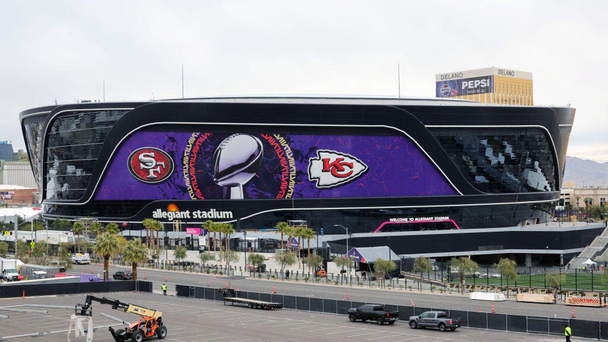 The exterior of Allegiant Stadium displaying logos for the Kansas City Chiefs and the San Francisco 49ers.