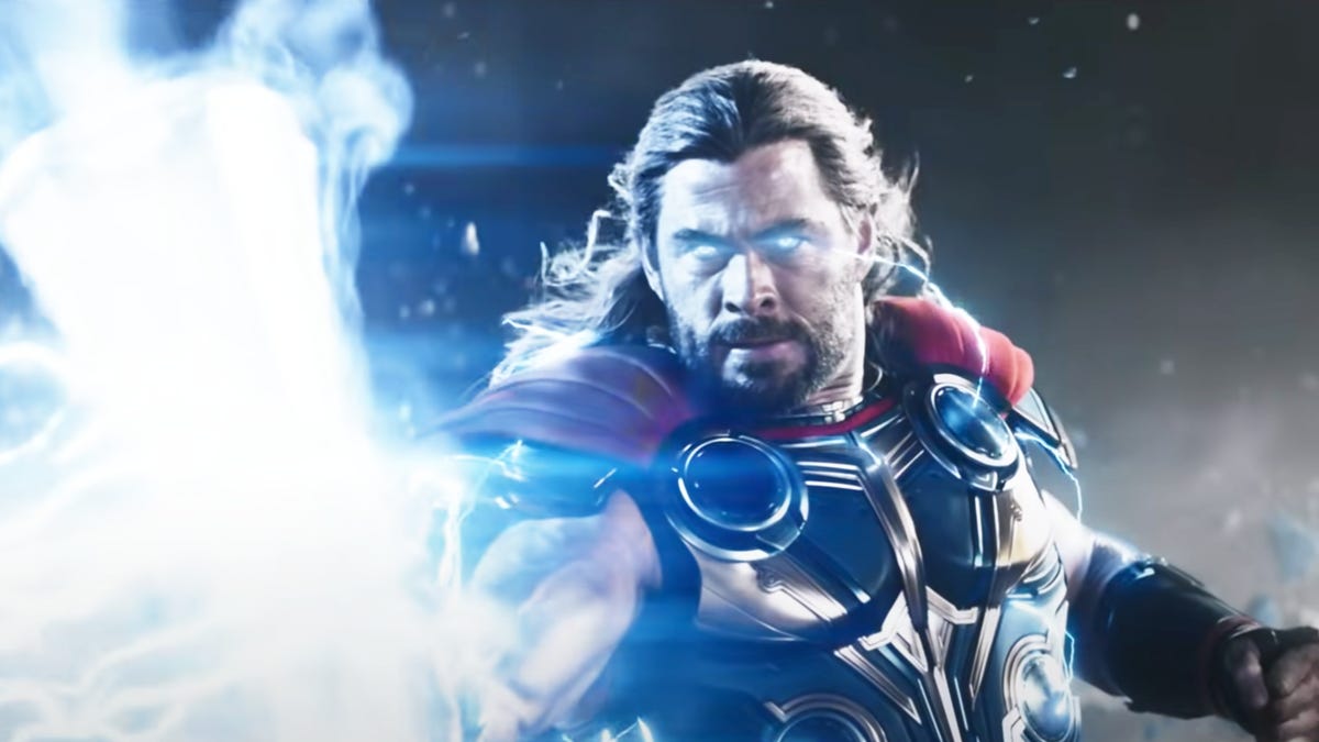 Thor holding Mjolnir with lightning lighting up his eyes