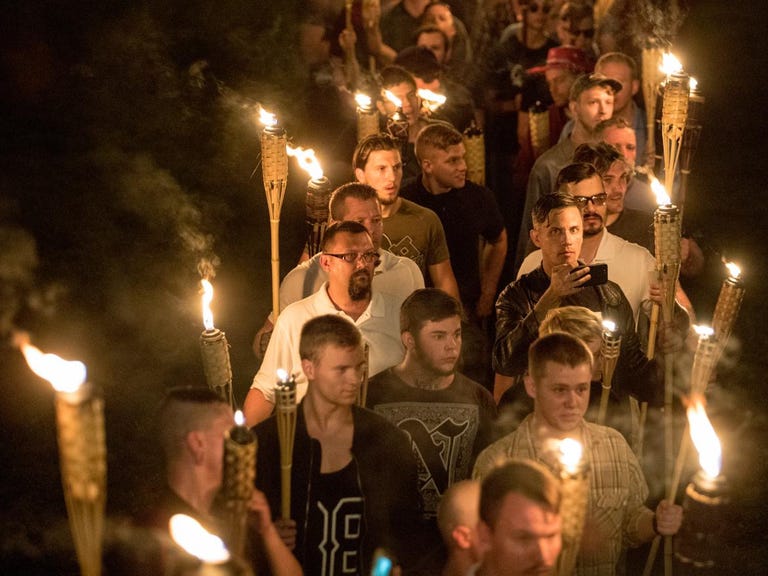White supremacists march with tiki torches through the University of Virginia campus the night before the Unite the Right rally in Charlottesville last August.