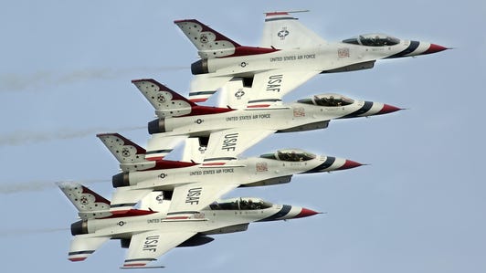 Four F-16 aircraft of the Air Force Thunderbirds flying in tight formation