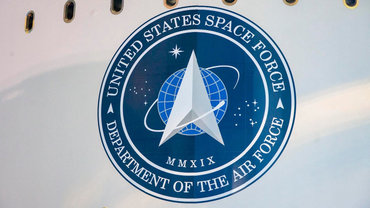 The chevron-style logo for the Space Force appears on the side of a rocket.