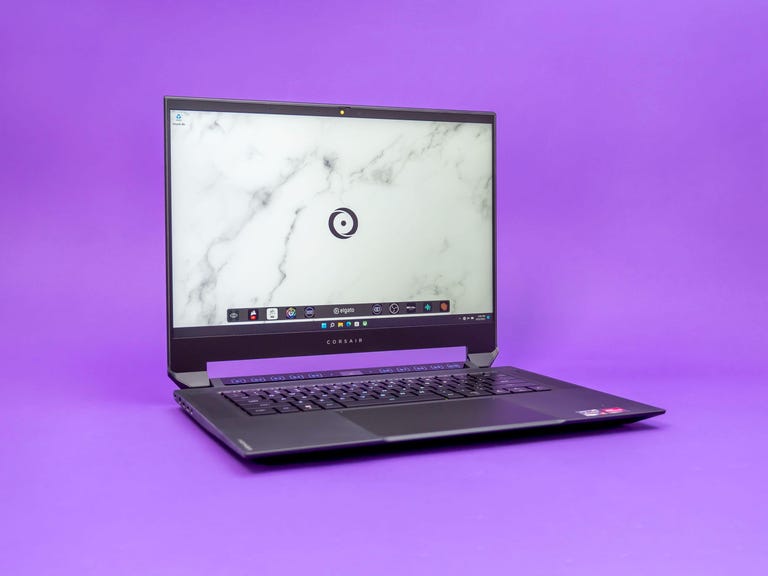 Corsair Voyager a1600 gaming laptop open on a purple background.