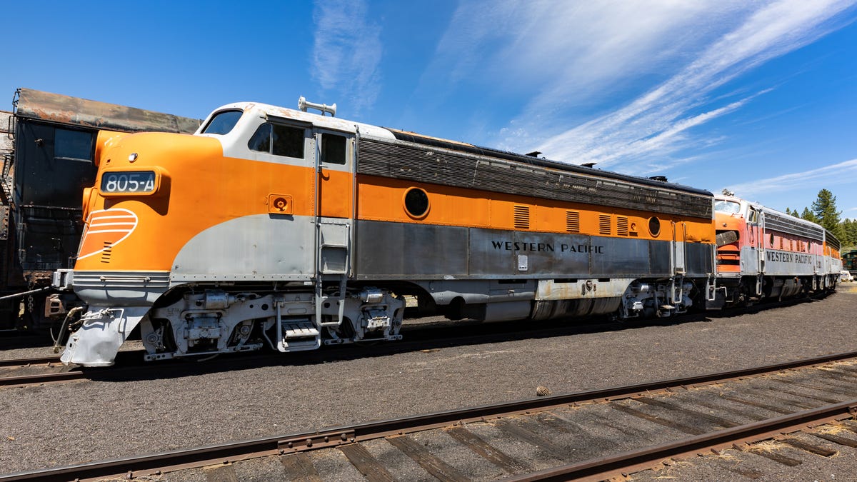 An orange and silver and gray diesel locomotive.