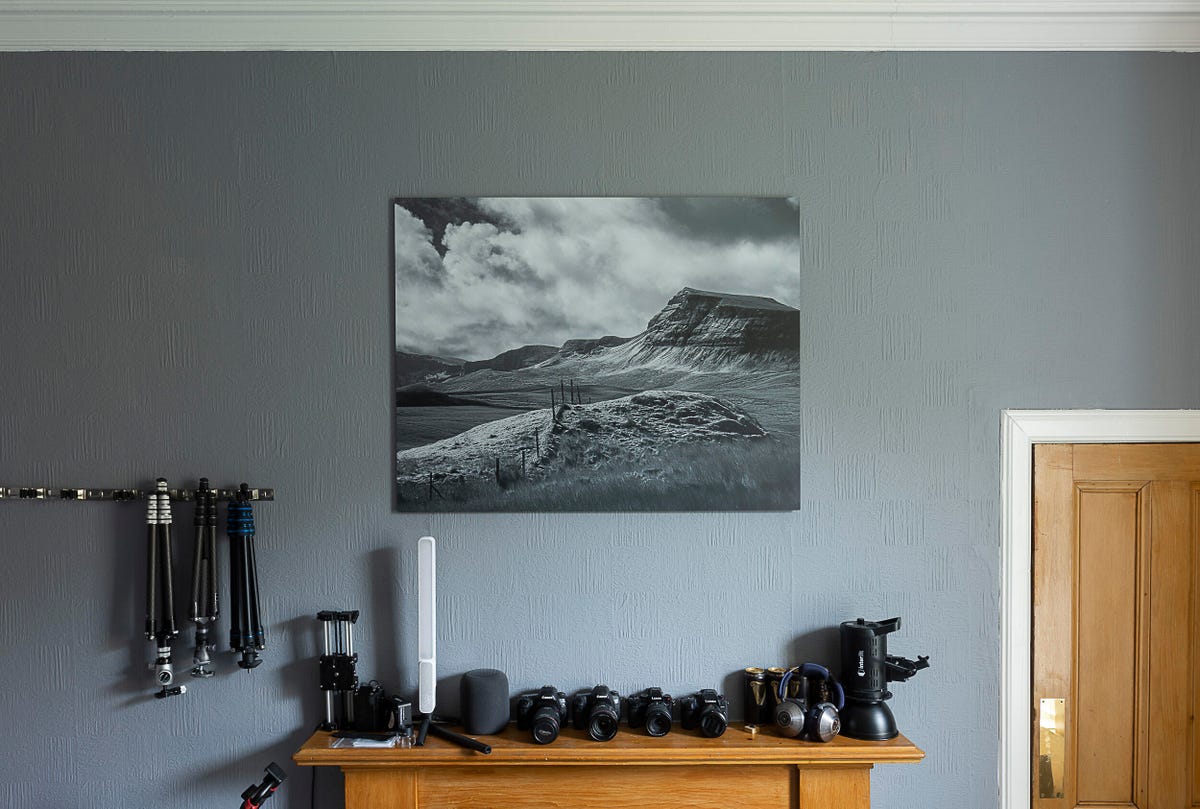 Image of a black and white print hanging over a fireplace