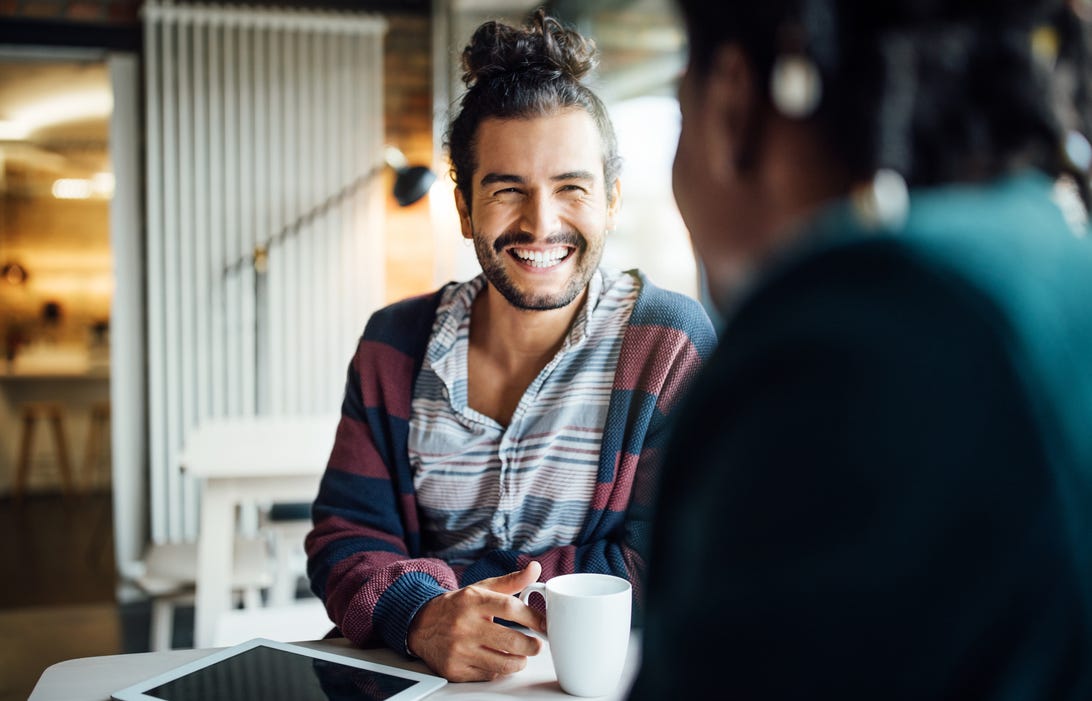 Happy man having a conversation with another person