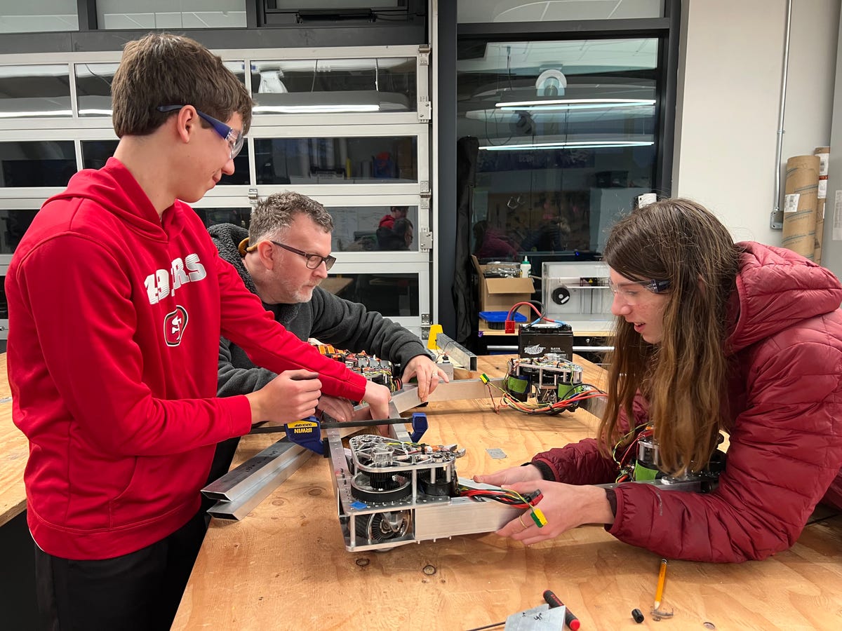 FRC 8033 team members Nate Welch (left) and Lewy Seiden (right) assemble and wire the robot's swerve drive bases in late January.