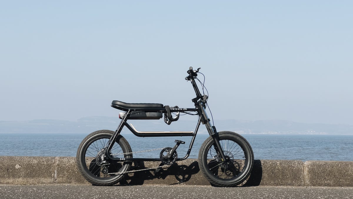 NewGen electric bike photographed with the sea behind.