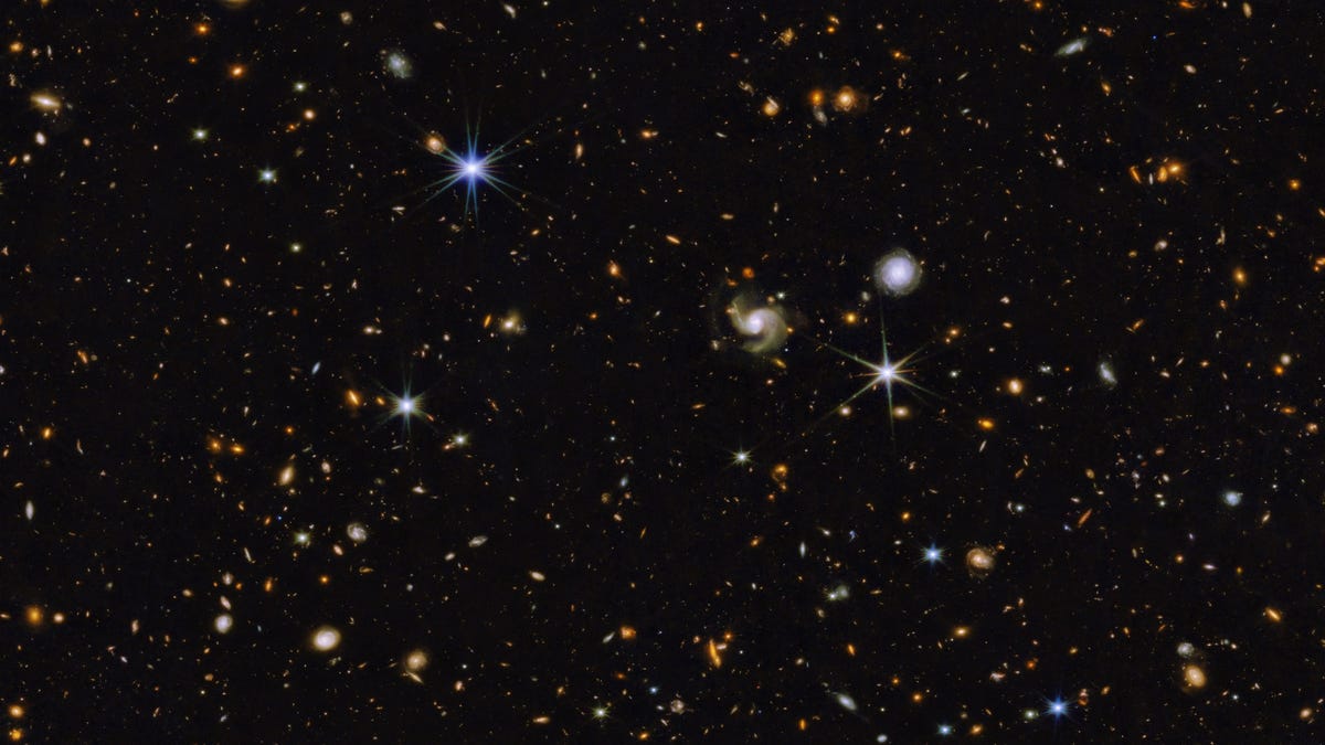 Field full of galaxies against darkness. So many galaxies, including some obvious spirals.