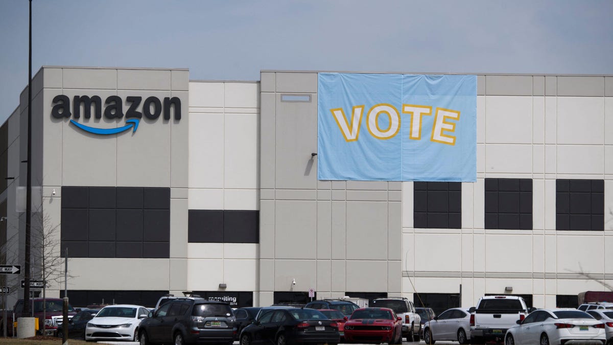 Amazon warehouse in Bessemer, Alabama, with a "vote" banner hanging on the side of the building