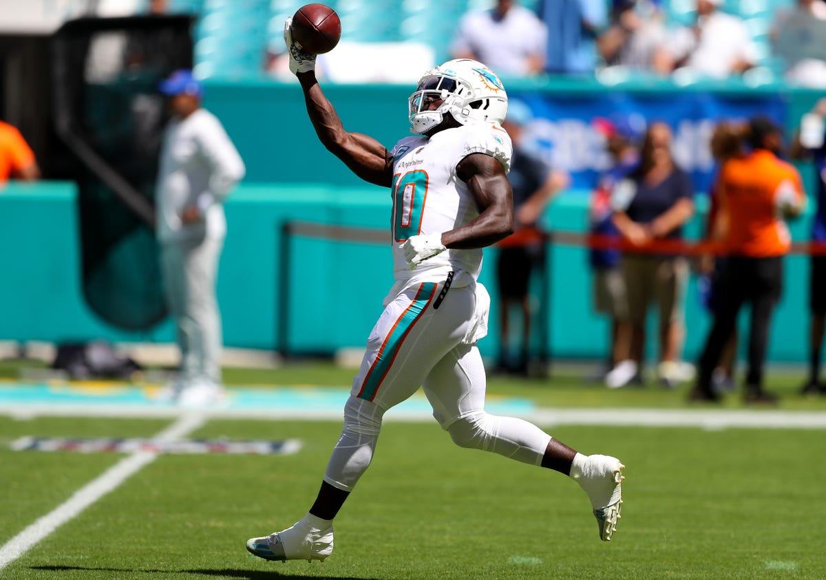 Tyreek Hill of the Miami Dolphins catches a football.