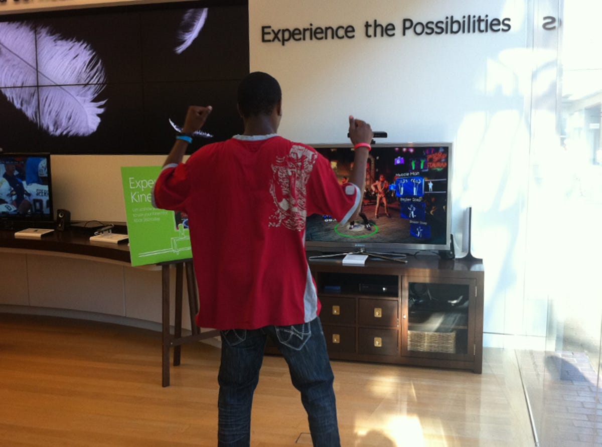 A shopper rocks it playing Kinect at a Microsoft retail store in San Diego.
