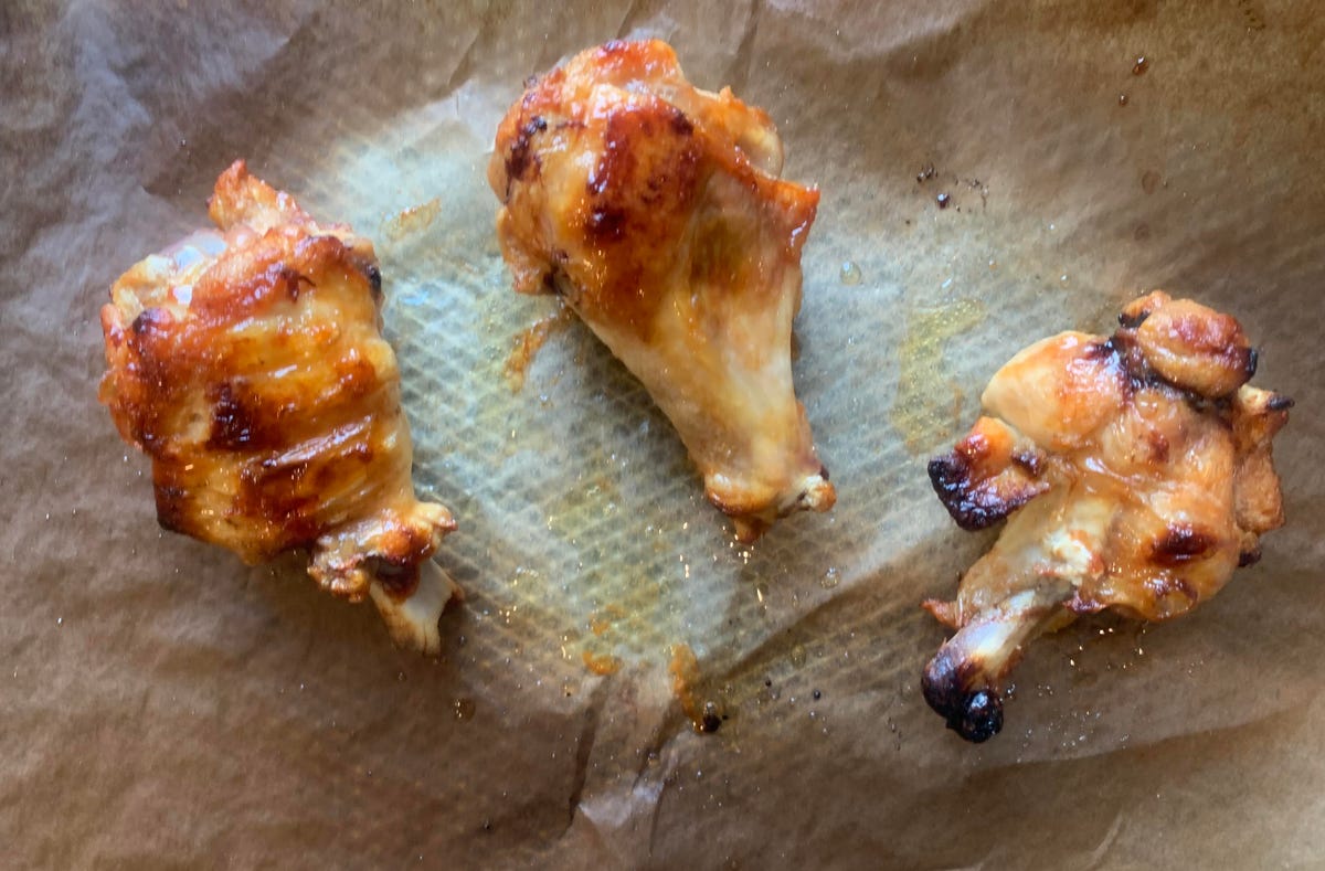 Three cooked chicken wings.